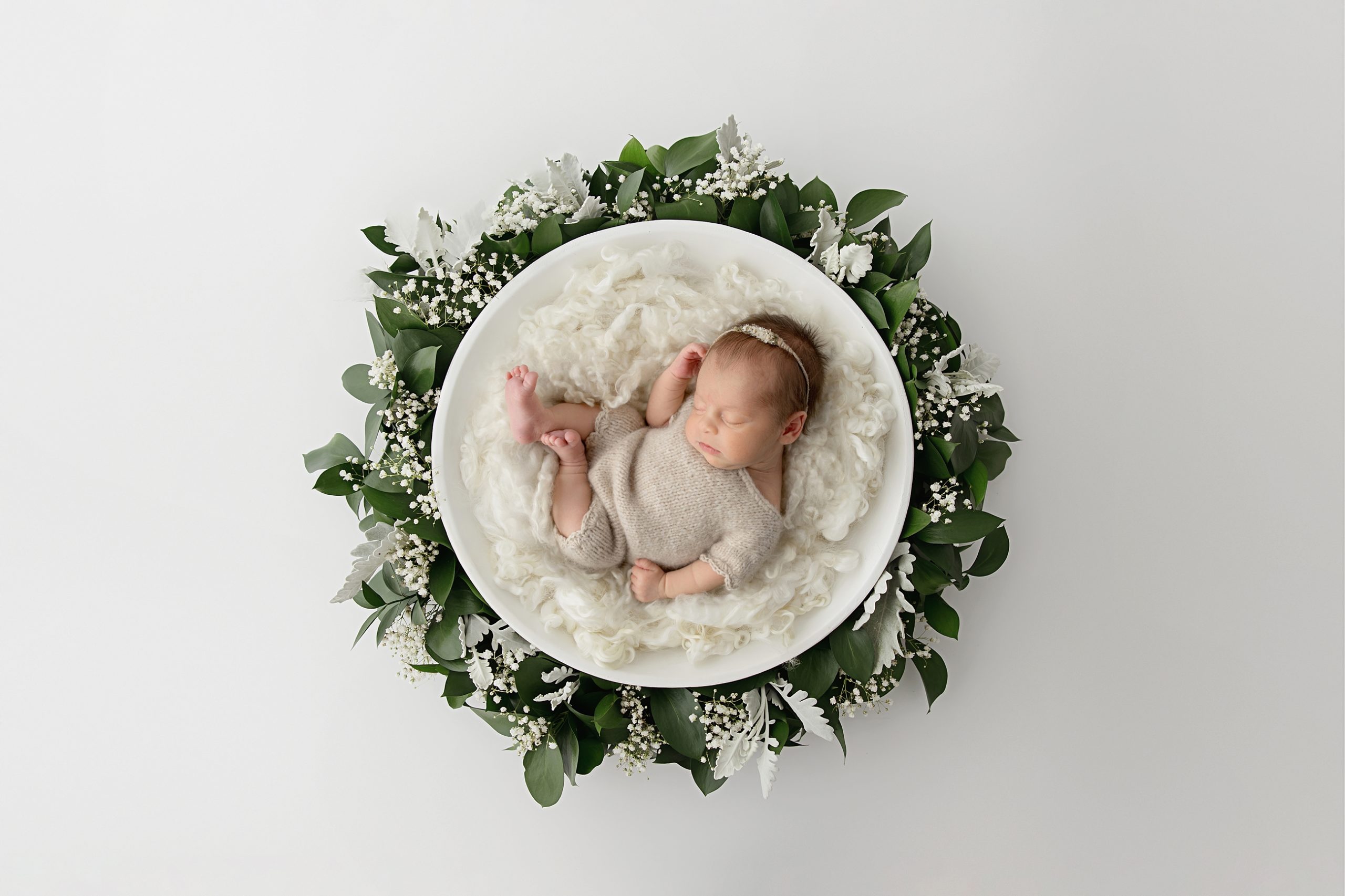 beautiful newborn portrait with a wreath of greenery baby plan